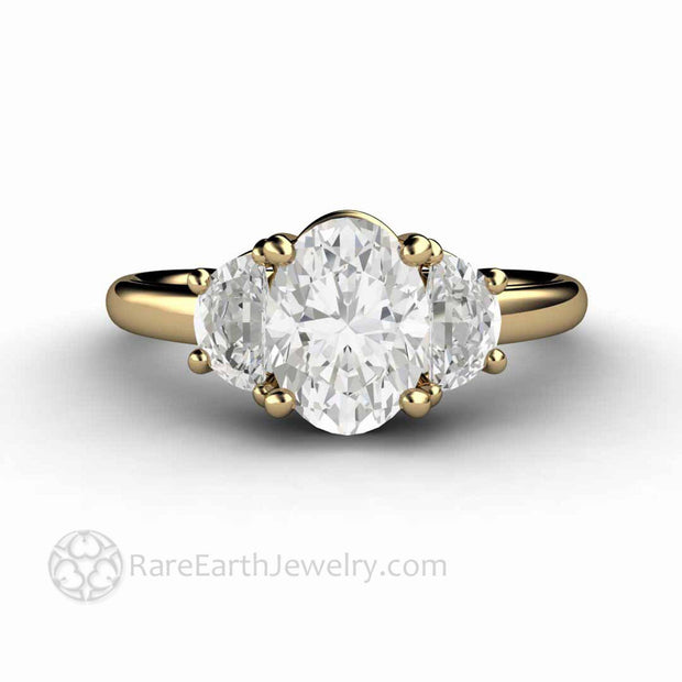 3 stone moissanite ring three stone setting with oval cut and half moons in yellow gold by Rare Earth Jewelry