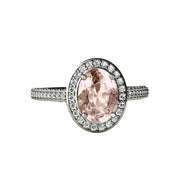 A Morganite Oval Halo Engagement ring with a Cathedral halo setting and pave set diamonds, unique pastel pink engagement ring in gold or platinum from Rare Earth Jewelry.
