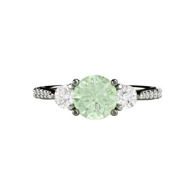 A Light Pastel Green Moissanite Engagement Ring with a 3 Stone Style and Forever One Moissanite Side Stones and Pave set Diamond Accents in gold or platinum from Rare Earth Jewelry.