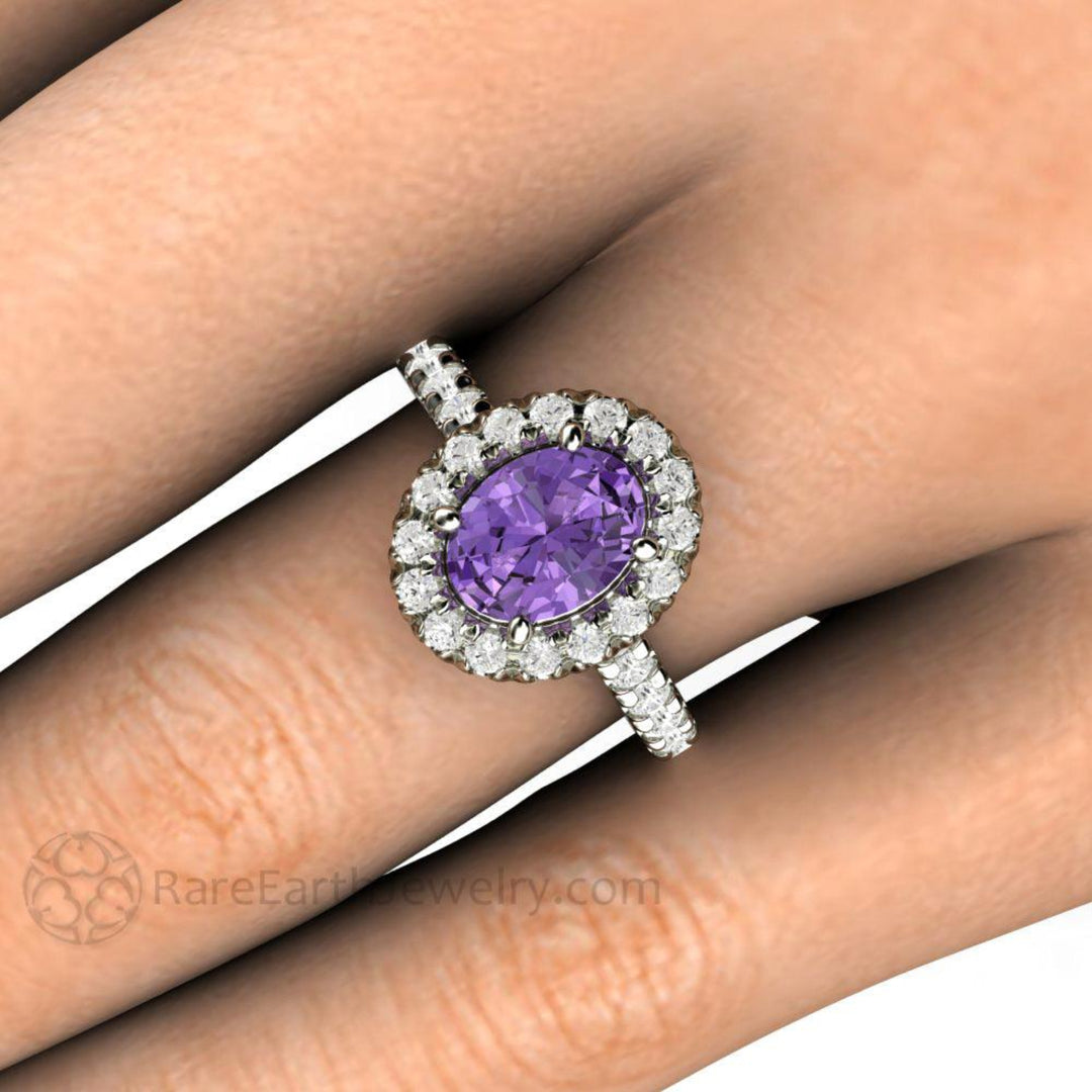 Close up of Purple Sapphire Engagement Ring on the Finger, Oval Halo with French Pave Diamonds | Rare Earth Jewelry