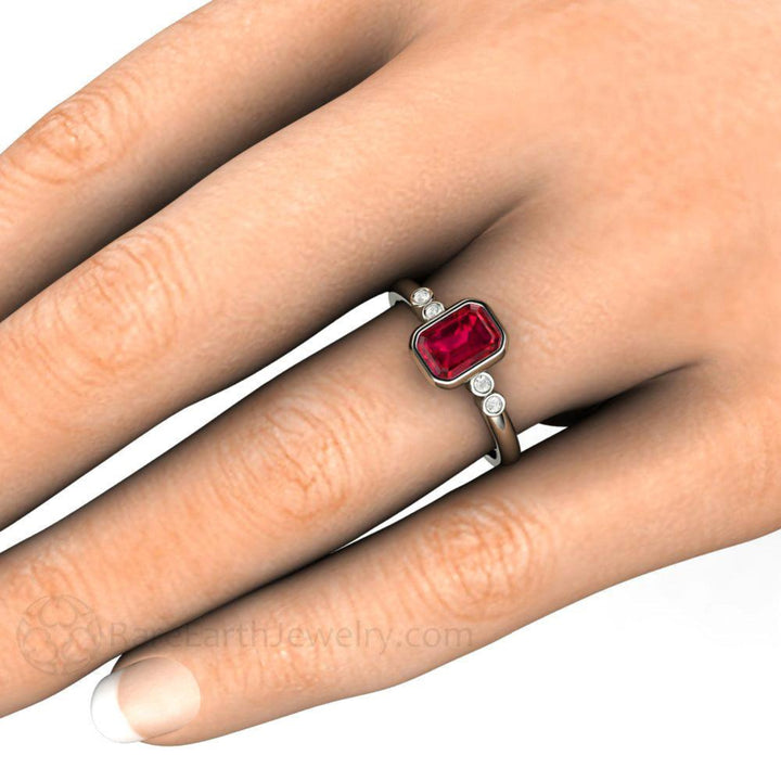 Emerald Cut Ruby Engagement Ring shown on the Hand, Ruby Bezel Set Ring, Solitaire with Diamonds | Rare Earth Jewelry