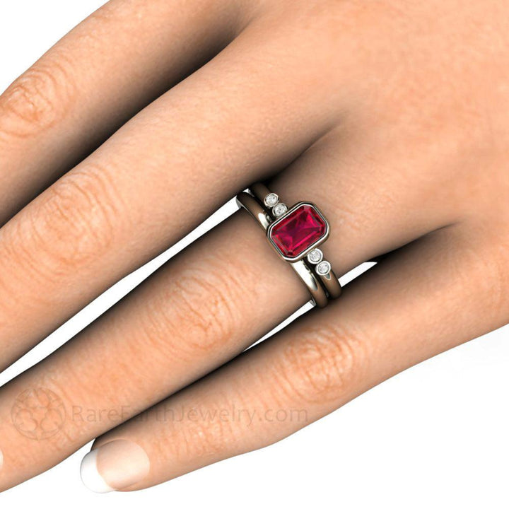 Ruby Engagement Ring, Modern Minimalist Wedding Set shown on the Finger. Emerald Cut Bezel Set Ruby Solitaire with Diamonds | Rare Earth Jewelry