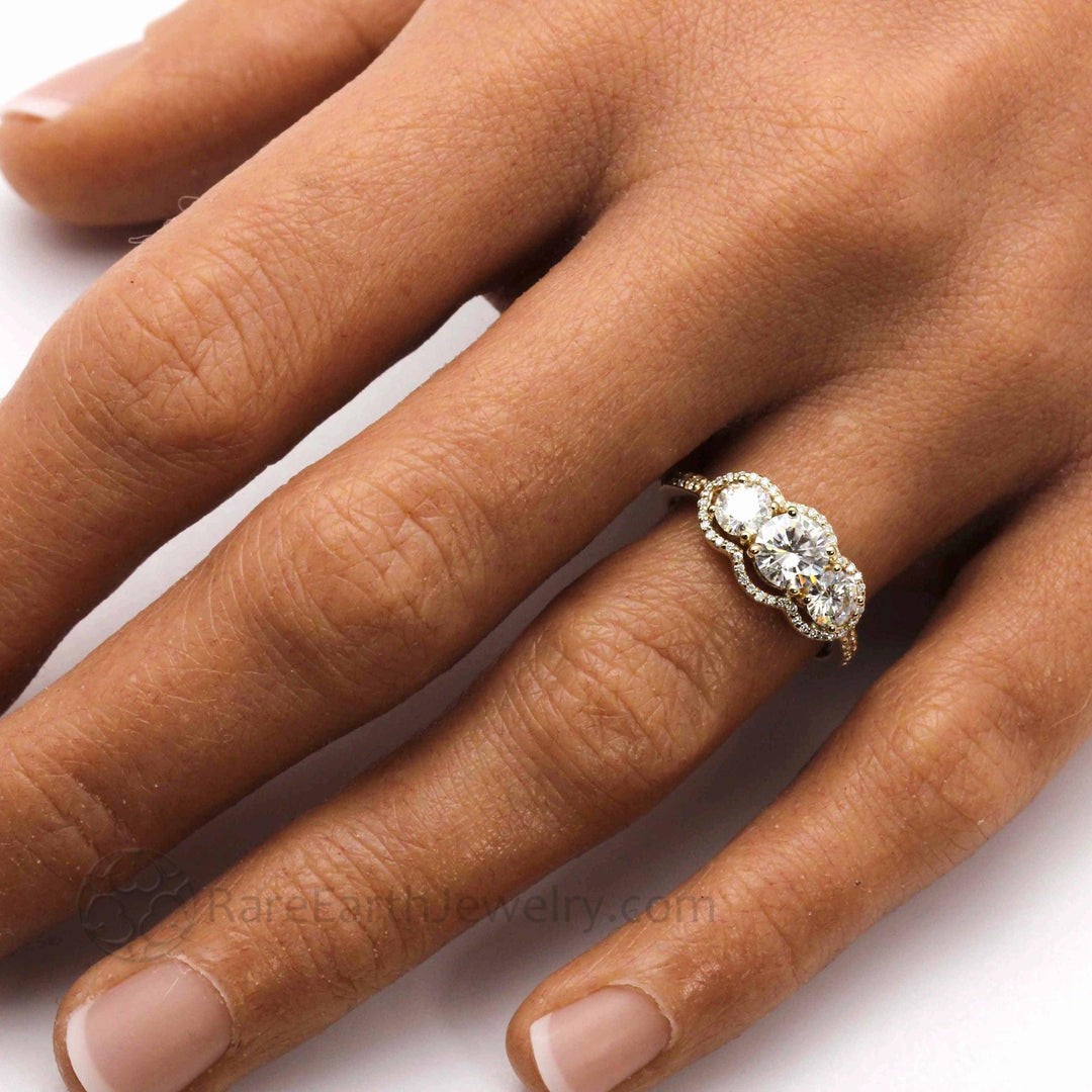 Vintage Inspired Moissanite Engagement Ring Three Stone Diamond Halo shown on the Hand, Eco-Friendly and Ethical Lab Grown Diamond Alternative Trio Ring | Rare Earth Jewelry